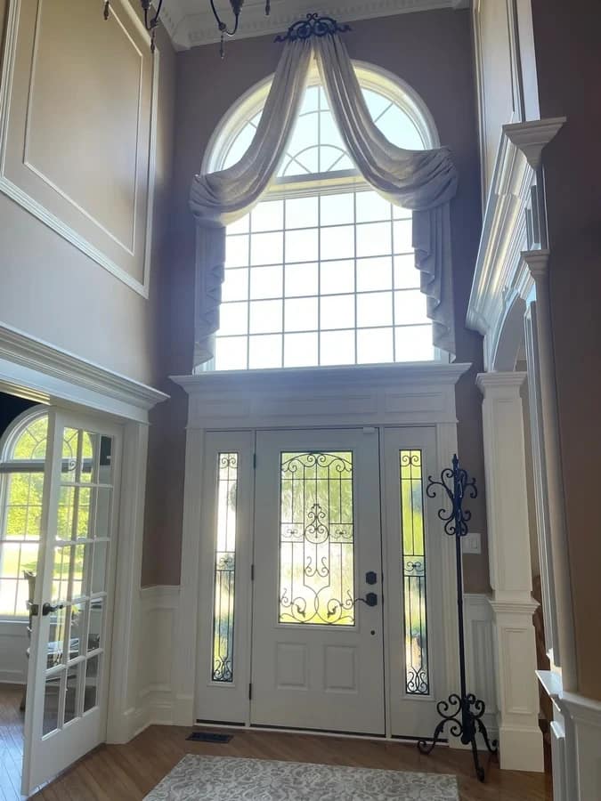 Foyer Archway & Crown Molding Design Custom archway trim, crown molding, and two-story foyer entry design