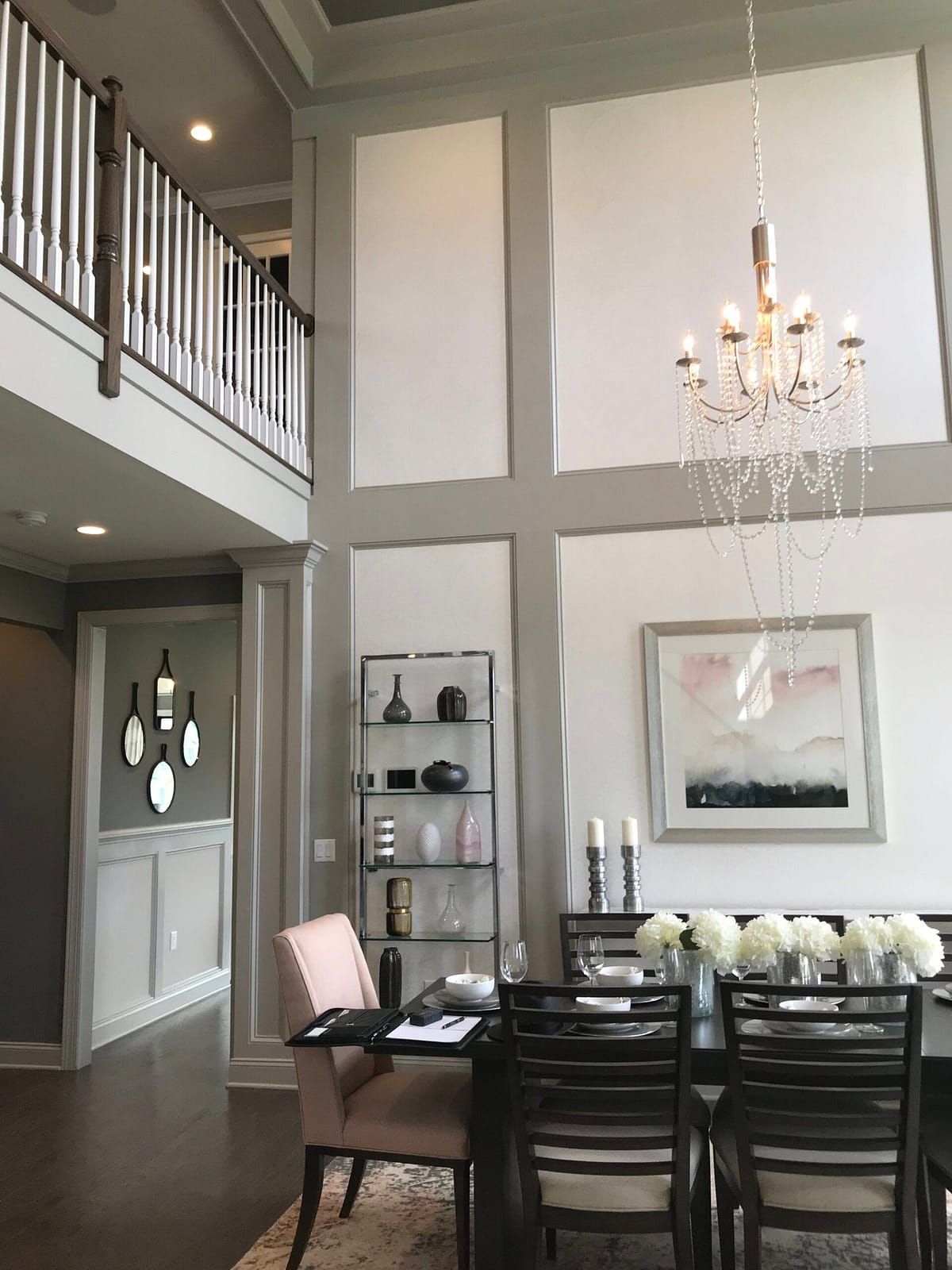 Two-Story Living Room Trimwork Grand two-story living room with custom grid wall paneling and interior design details