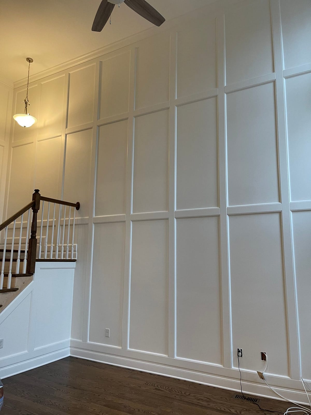 Monmouth County Wall Panel Showcase High-ceiling wall panel installation along grand staircase in Monmouth County