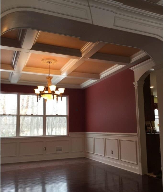 Custom wainscoting and coffered ceiling installed in a formal dining room