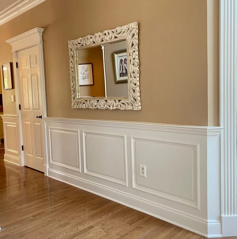 Classic raised-panel wainscoting with chair rail and decorative door casing