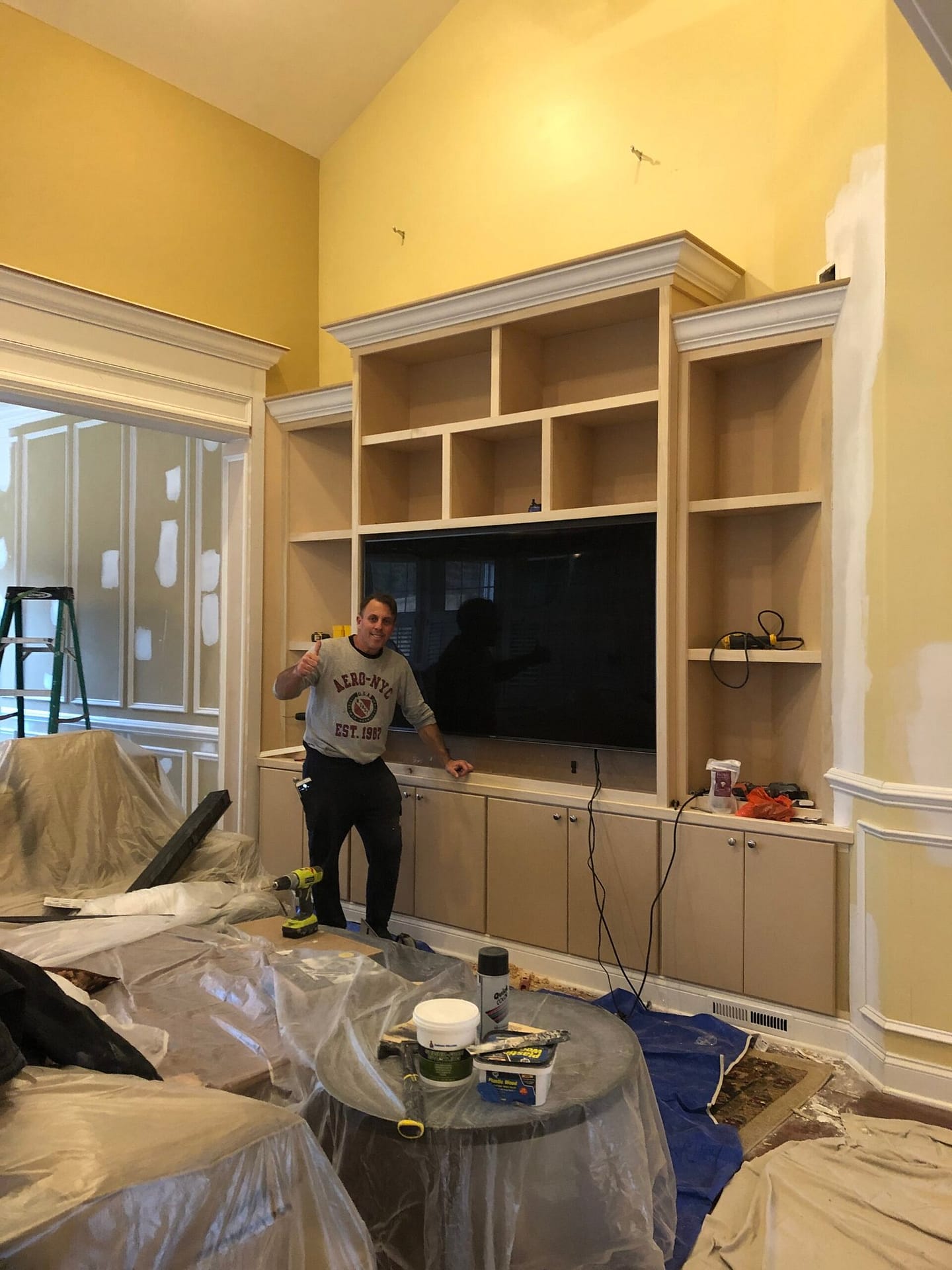Custom natural wood built-in bookcases surrounding a window in a Monmouth County NJ home