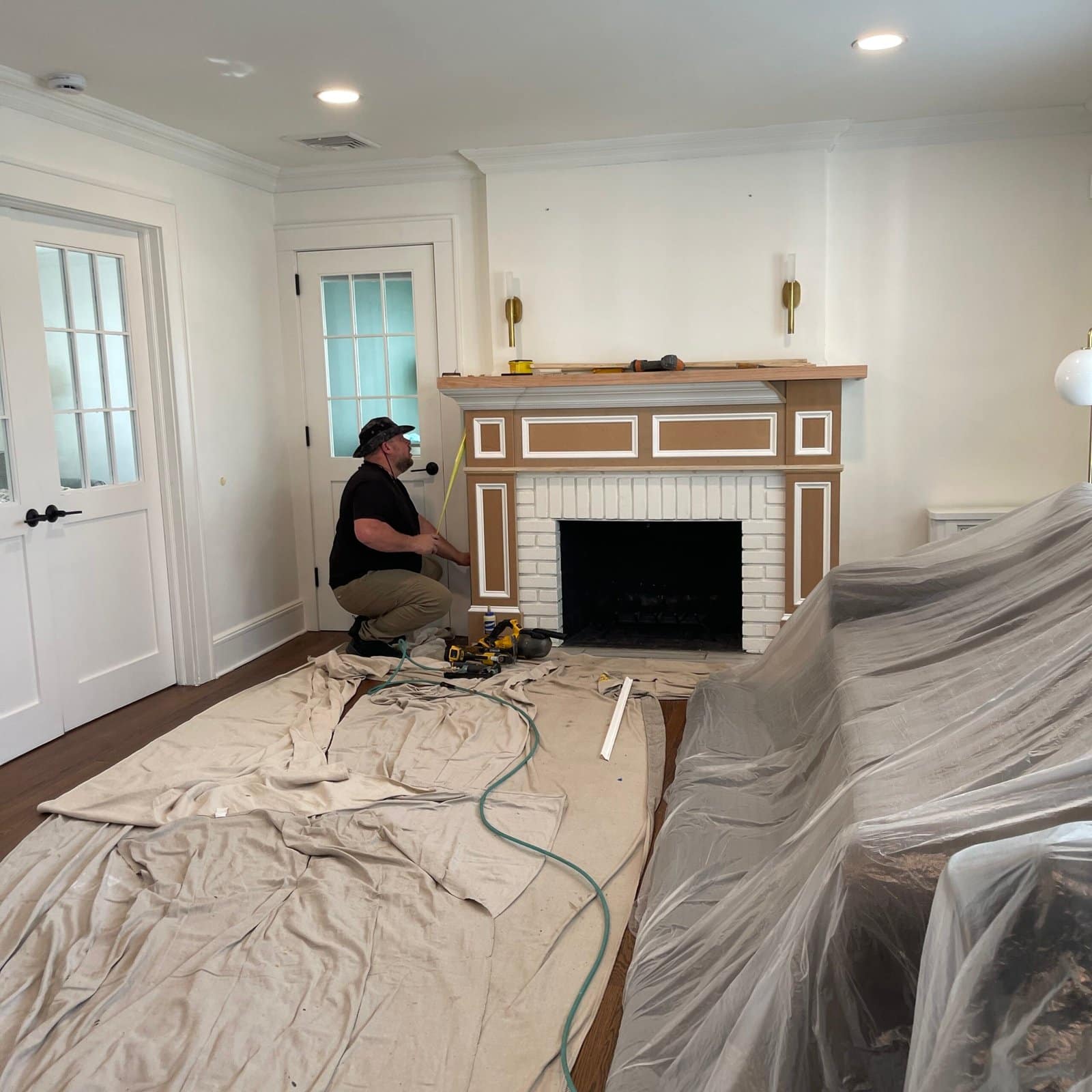 Marcio installing a custom fireplace mantel in a Monmouth County NJ home